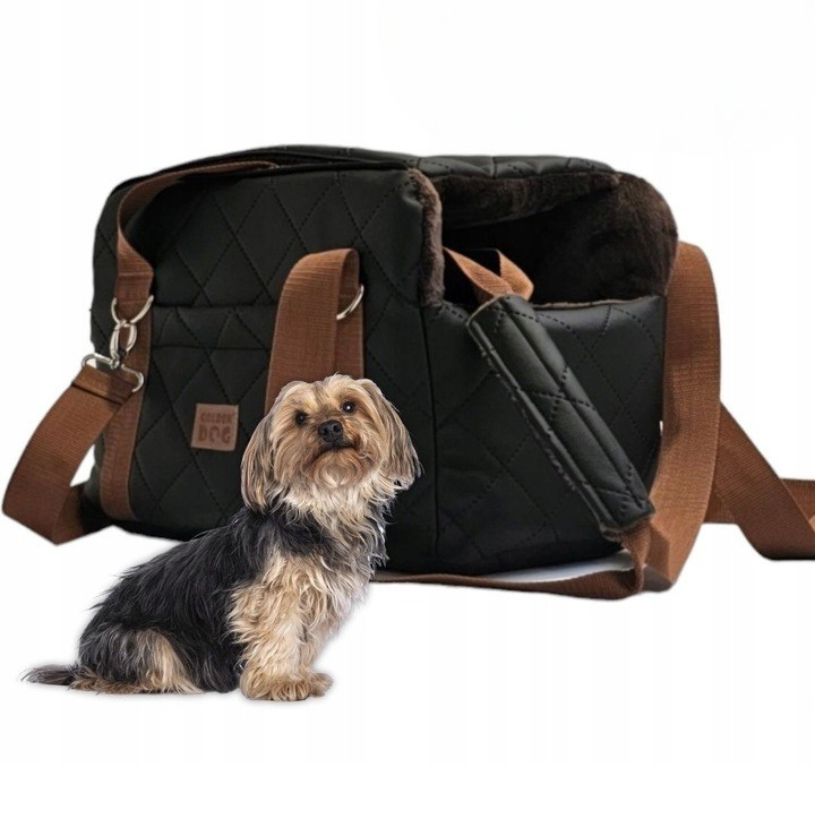 Black quilted dog travel bag with brown shoulder straps and soft plush interior; labelled “Deluxe Dog” — a stylish and secure pet carrier for small breeds.