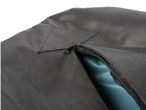Close-up of a dog bed with zippered cover being opened — washable upholstery detail showing how the cover can be removed for cleaning