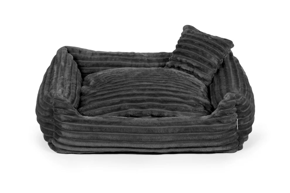 Black plush dog bed with ribbed texture and shredded foam filling — Dream model, soft-touch fabric, machine washable, and ideal for dogs who love to snuggle