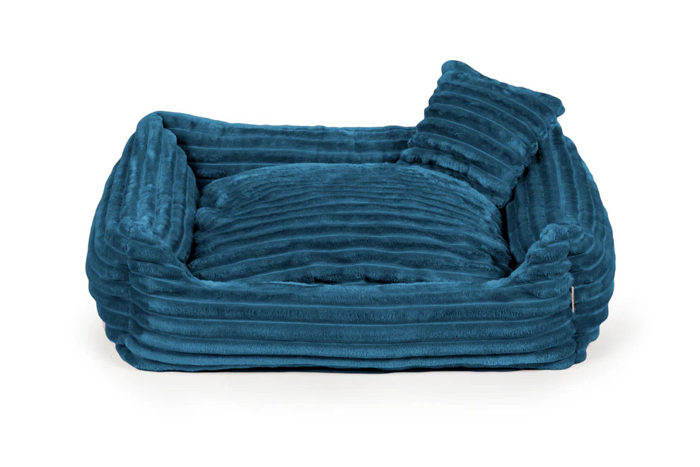 Blue plush dog bed with ribbed texture and shredded foam filling — Dream model, soft-touch fabric, machine washable, and ideal for dogs who love to snuggle