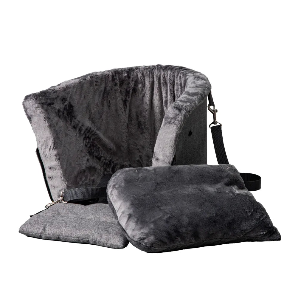 Grey dog car seat securely mounted between the front seats of a car with tan leather upholstery; features padded sides, side zip and a branded Golden Dog patch — designed for small pets to travel safely and stylishly