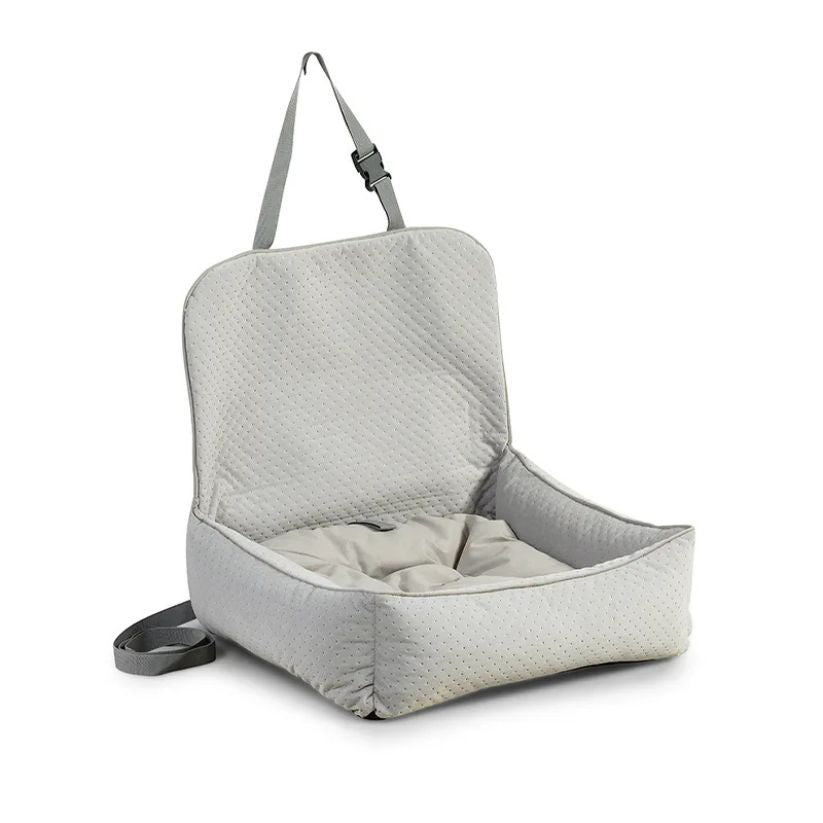 A soft, grey upholstered dog car seat with raised backrest and safety straps, designed for secure and comfortable travel in vehicles.