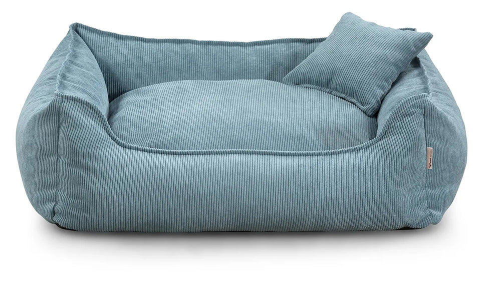 Close-up of Lucky dog bed in blue corduroy fabric, showing zippered cushion and durable stitching