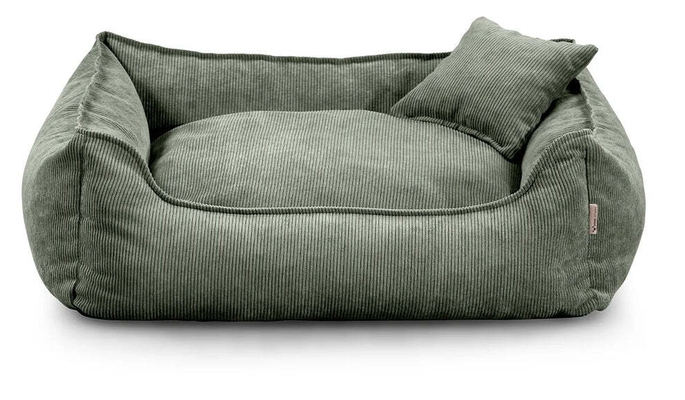 Close-up of Lucky dog bed in green corduroy fabric, showing zippered cushion and durable stitching