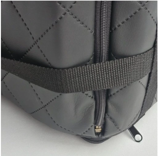 Stylish grey quilted dog car seat with red piping — securely fastened for comfortable car travel