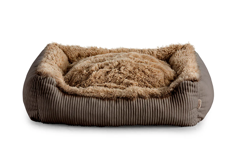 Shaggy dog bed in brown colour fabric with small pillow.