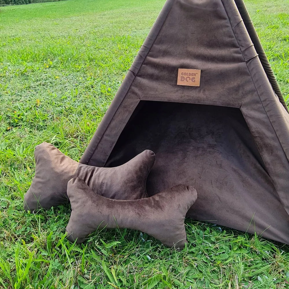 Tipi-style dog bed made from dark brown Royal Velvet fabric — includes soft cushion and bone-shaped pillows, supported by wooden poles