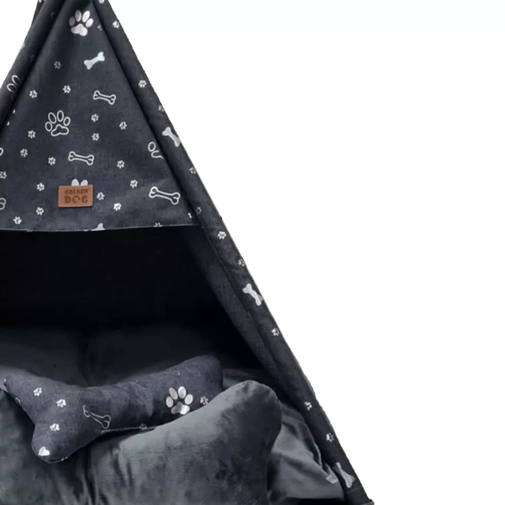Tipi-style dog bed made from dark grey fabric with silver paw print pattern — includes matching cushion and bone-shaped pillow, supported by wooden poles