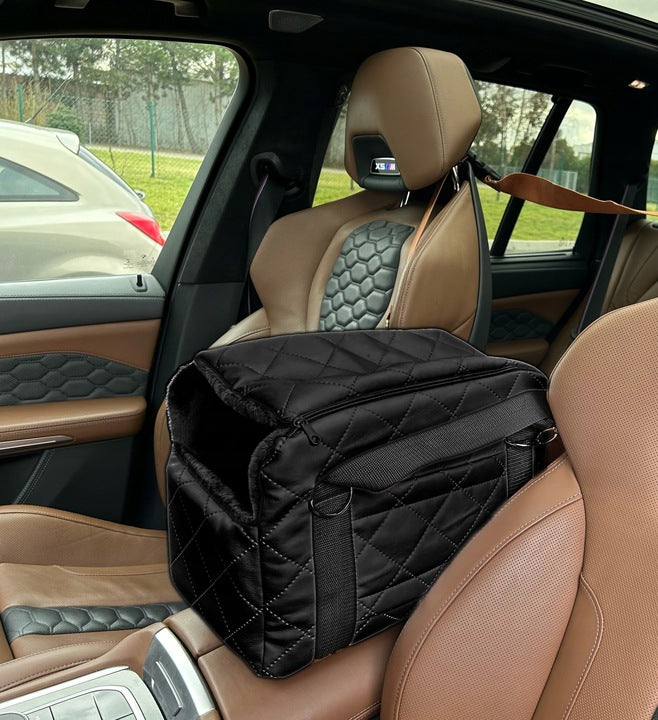 A black quilted pet carrier bag with metallic fittings and an adjustable shoulder strap, suitable for small dogs or cats—ideal for car journeys or daily walks.