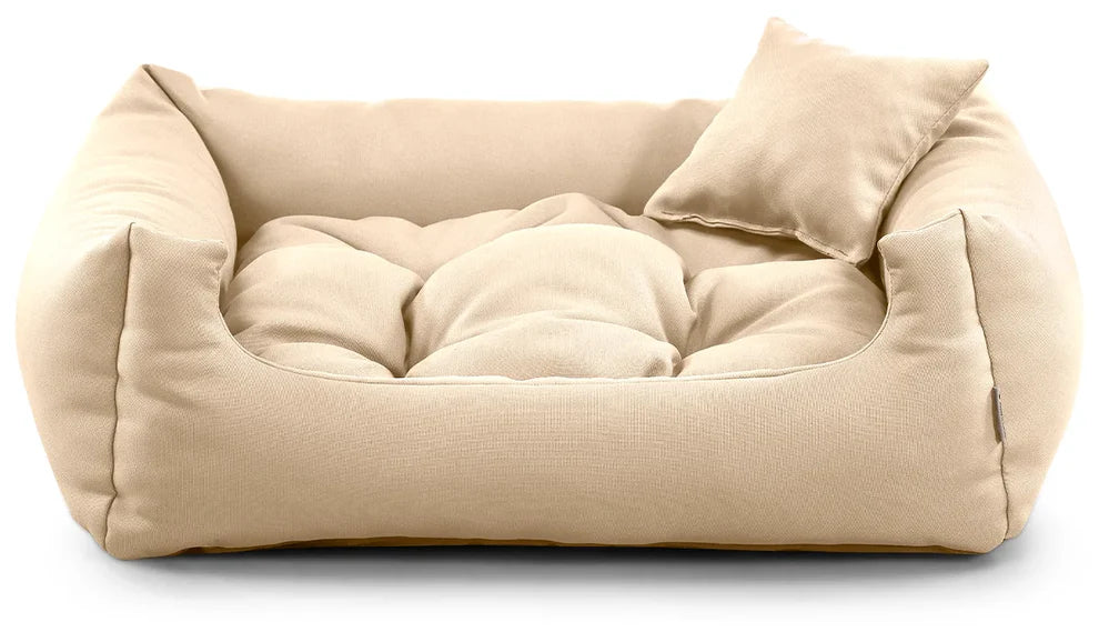 Beige corduroy dog bed with raised edges and cushion.