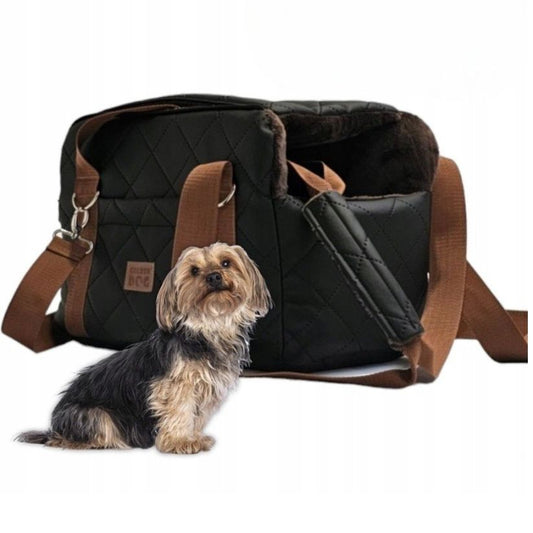 Black quilted dog travel bag with brown shoulder straps and soft plush interior; labelled “Deluxe Dog” — a stylish and secure pet carrier for small breeds.