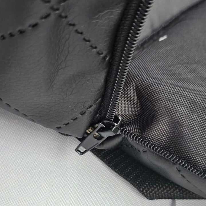 Black quilted dog car seat cover ; includes adjustable securing straps and fits standard car seats — a protective travel accessory for pet owners.