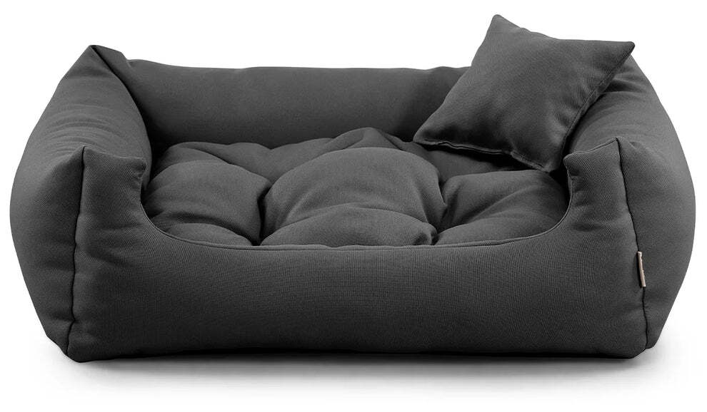 Dark grey corduroy dog bed with raised edges and cushion.