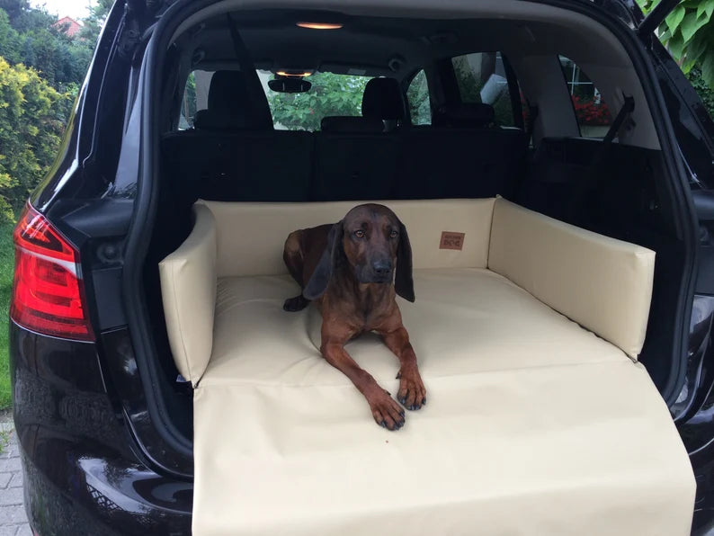Cream eco-leather boot mat for dogs fitted in a car’s cargo area — features raised foam-filled sides and bumper flap for protection, designed to shield against dirt, moisture, and scratches