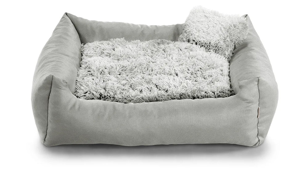 Fluffy Nelo dog bed in light grey colour fabric with small pillow.