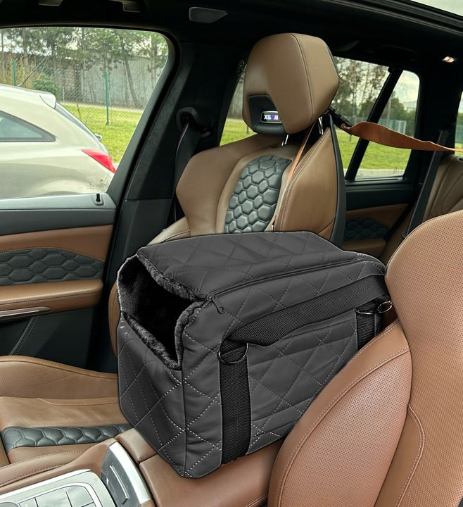 Graphite quilted dog travel bag with brown shoulder straps and soft plush interior — a stylish and secure pet carrier for small breeds.