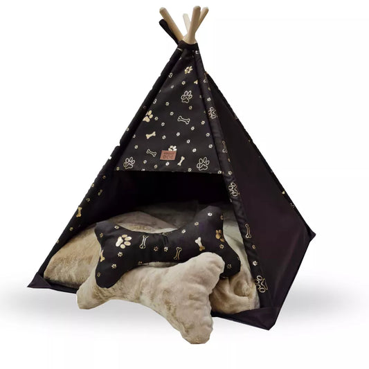 Tipi-style dog bed made from dark browfabric with golden paw print pattern — includes matching cushion and bone-shaped pillow, supported by wooden poles