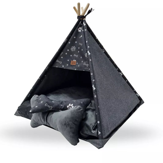 Tipi-style dog bed made from dark grey fabric with silver paw print pattern — includes matching cushion and bone-shaped pillow, supported by wooden poles