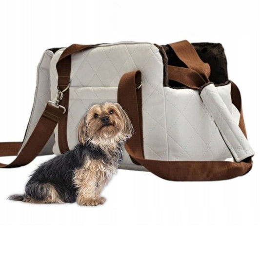 White quilted dog travel bag with brown shoulder straps and soft plush interior;  — a stylish and secure pet carrier for small breeds.
